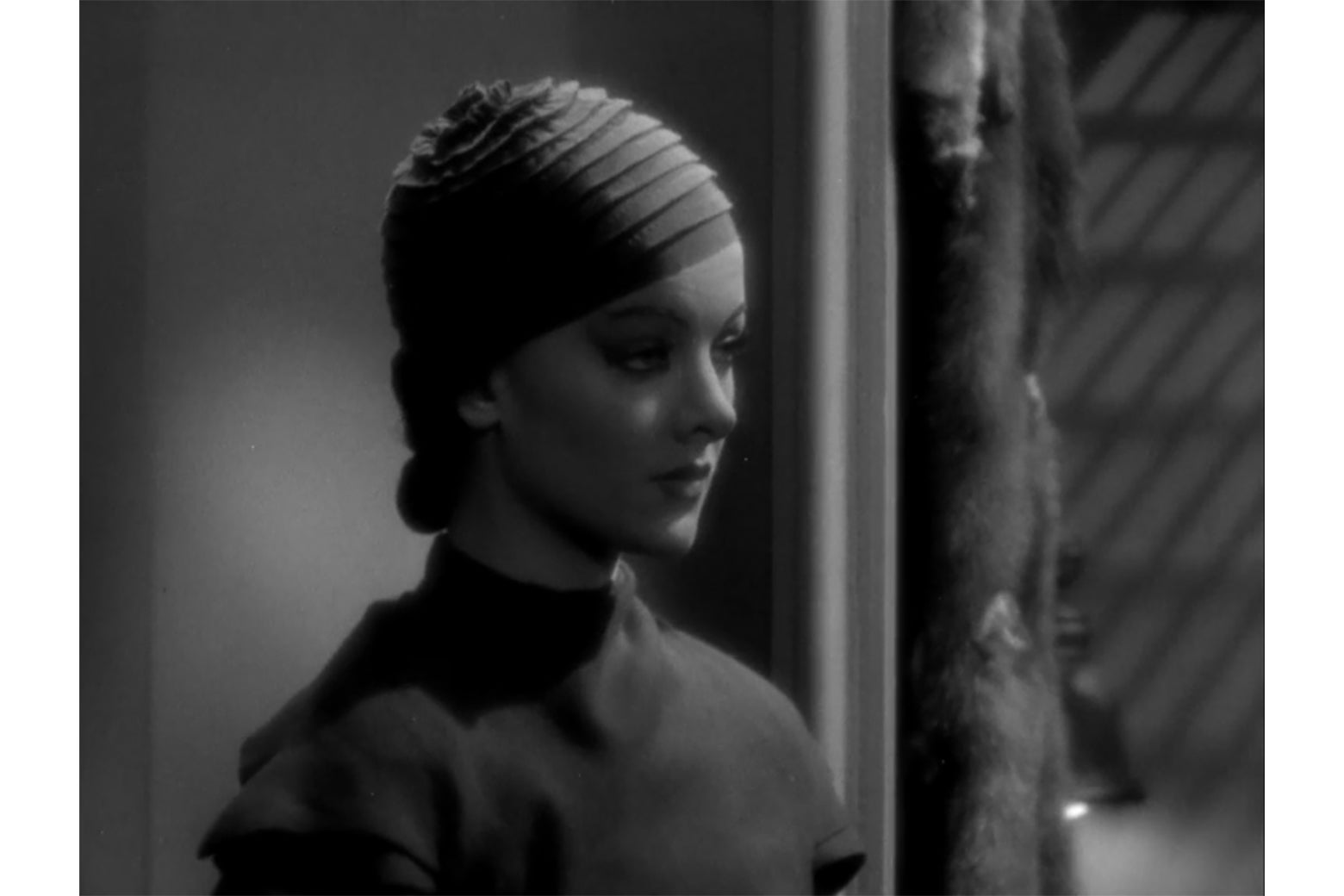 Myrna Loy in exaggerated makeup, in a still from Thirteen Women.