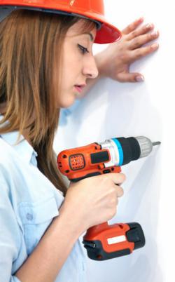 Woman with a power drill.