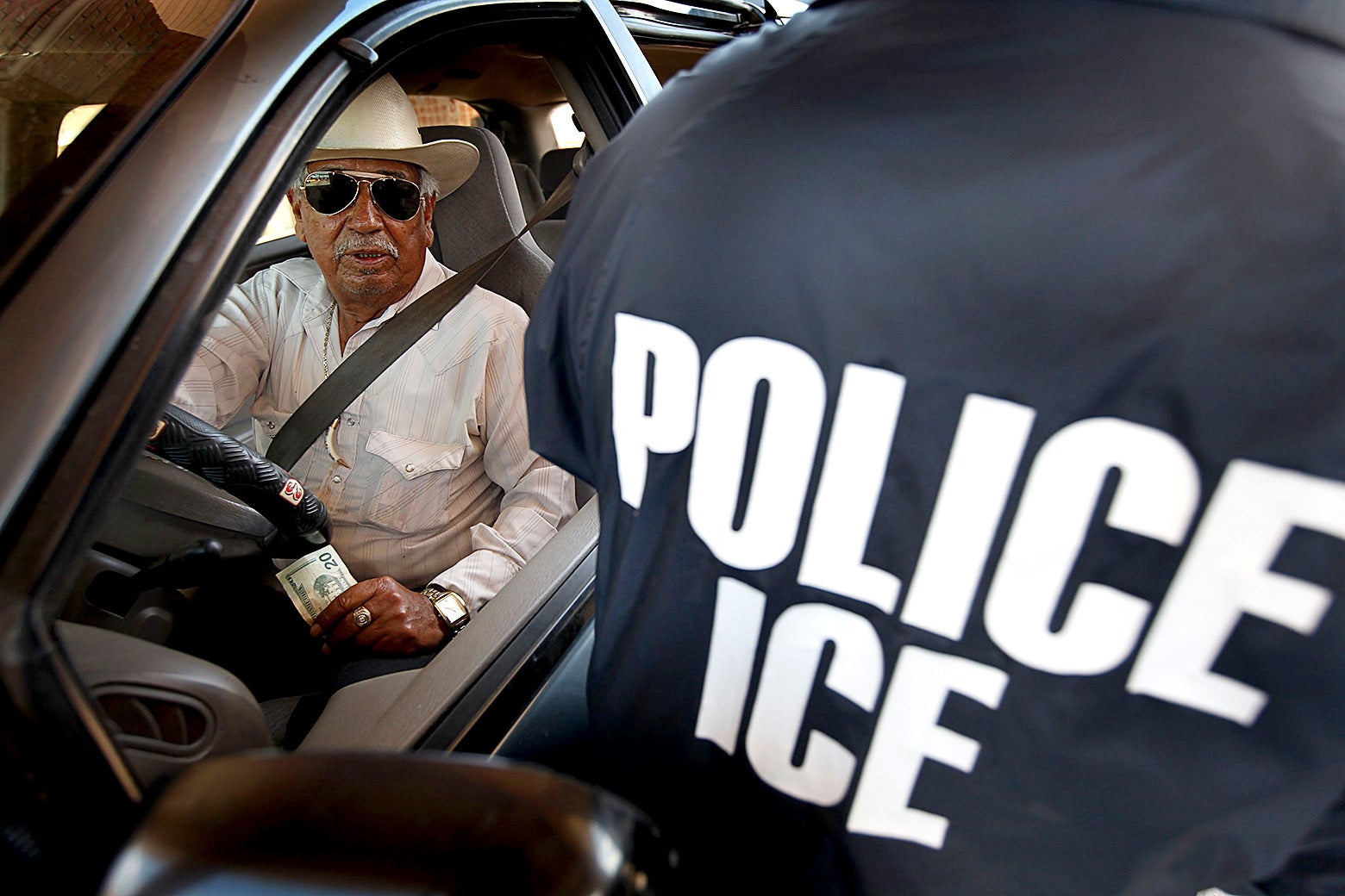 A special agent from ICE searches a vehicle heading into Mexico at the Hidalgo border crossing on in Hidalgo, Texas. 