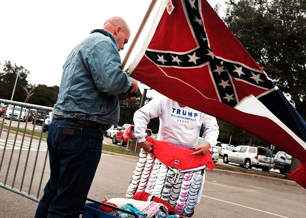A supporter of the Republican presidential frontrunner Donald Trump purchases Trump merchandise while waiting to hear him speak at the Mississippi Coast Coliseum on January 2, 2016 in Biloxi, Mississippi. 
