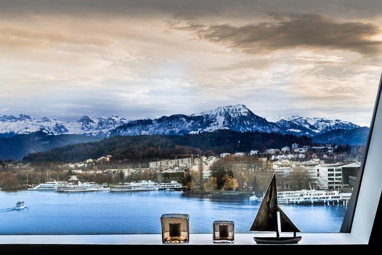 A window overlooking a lake and mountains.