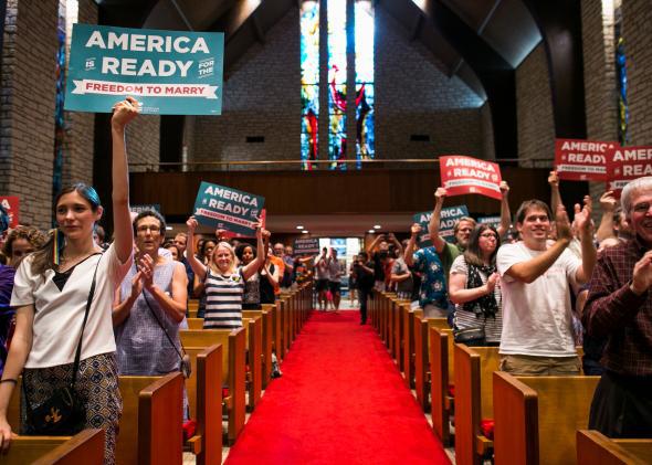 A crowd stands to applaud at the Central Presbyterian Church in celebration of Friday’s same-sex marriage announcement on June 26, 2015, in Austin, Texas.