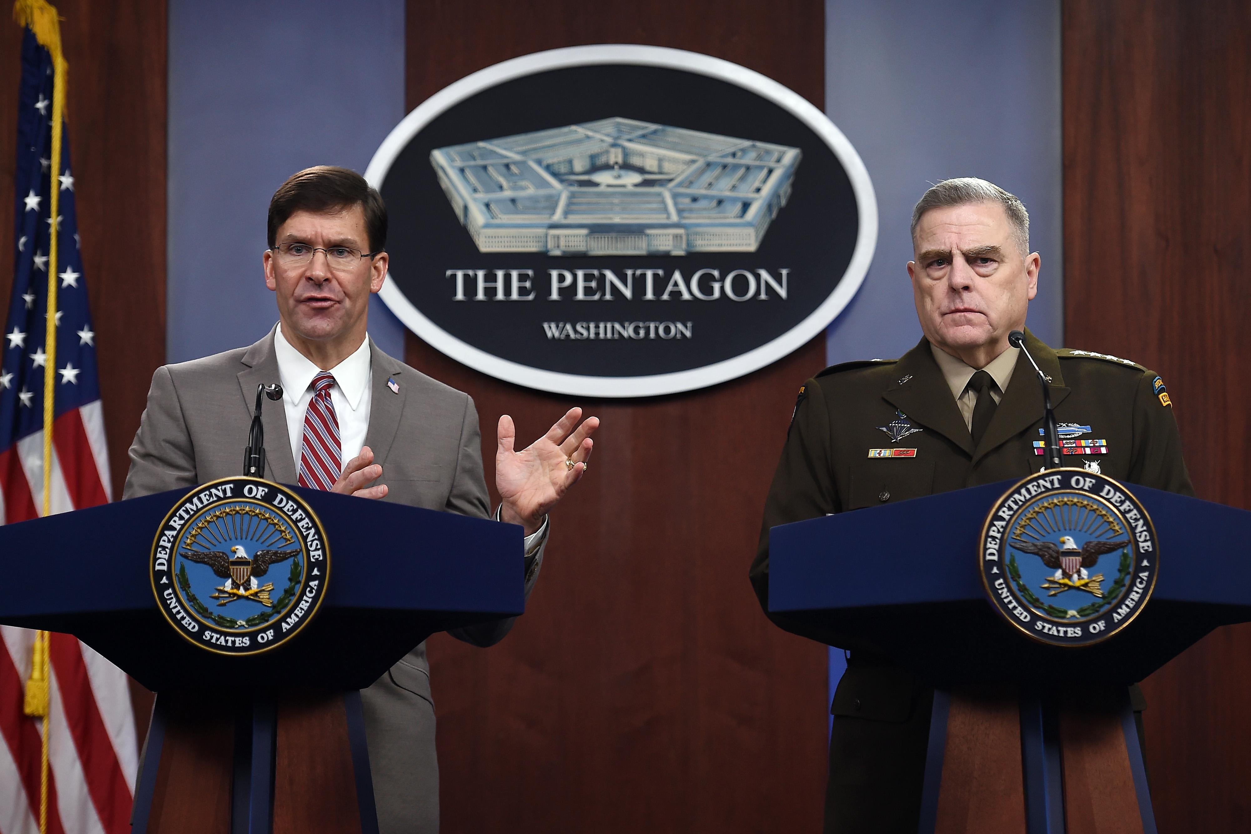 Esper and Milley stand at podiums at the Pentagon.