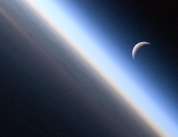 The old Moon, rising over the Earth's morninglit edge.