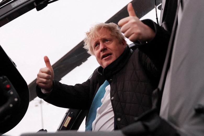 Boris Johnson in a black quilted jacket giving two thumbs up from a helicopter