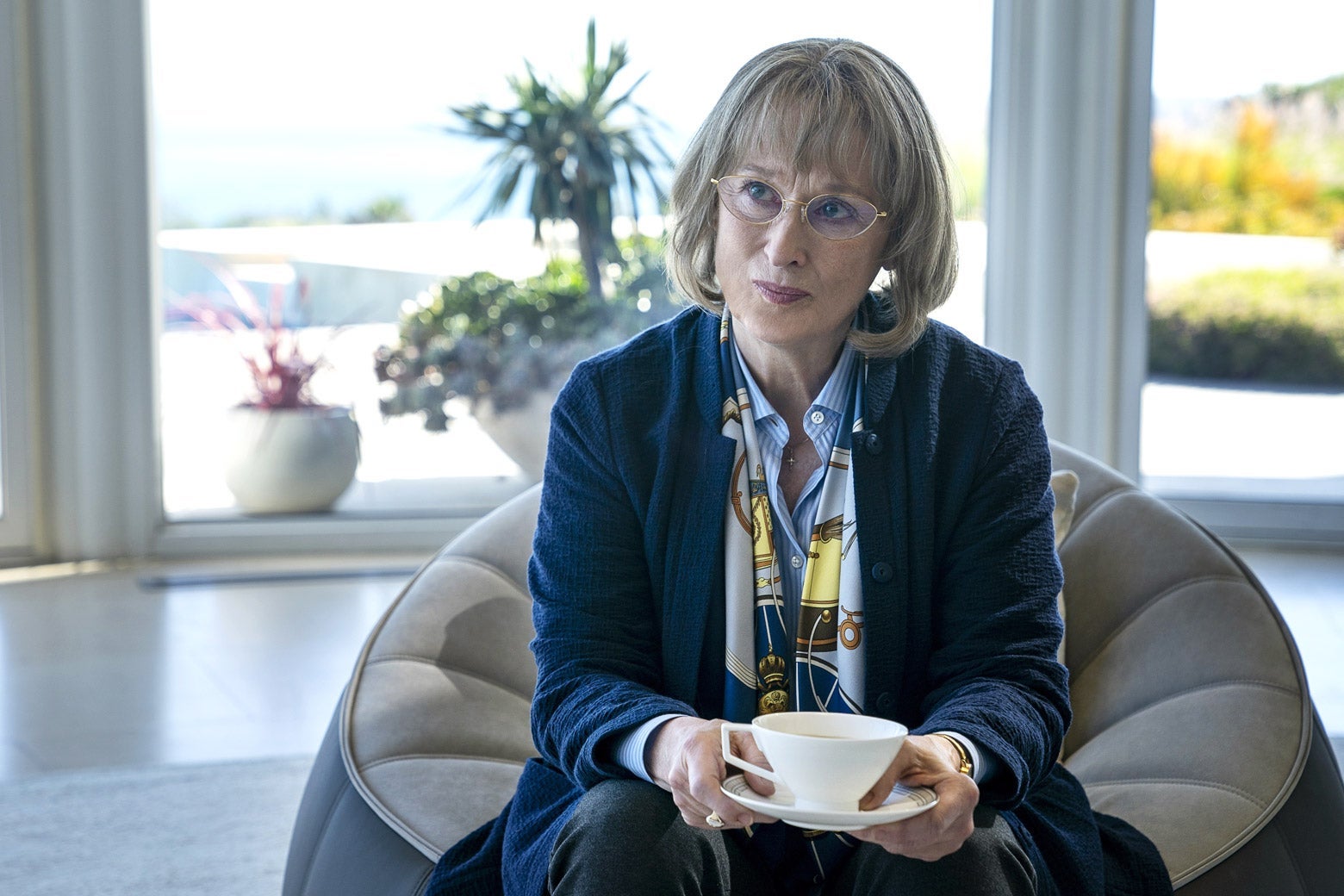 Meryl Streep as Mary Louise, holding a tea cup and saucer.