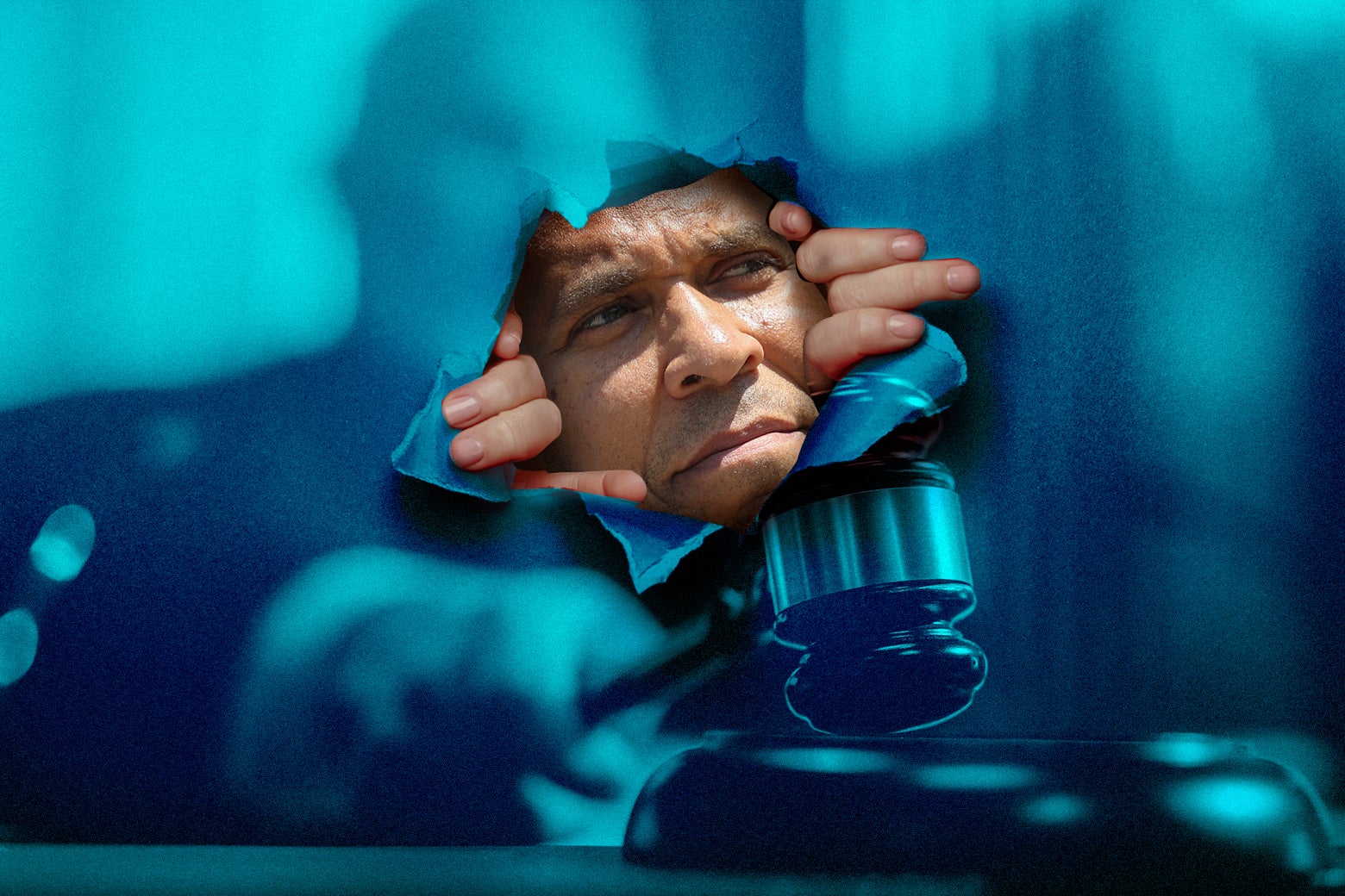 A photo illustration of Cory Booker peeking through a tear in another image of a judge with a gavel.