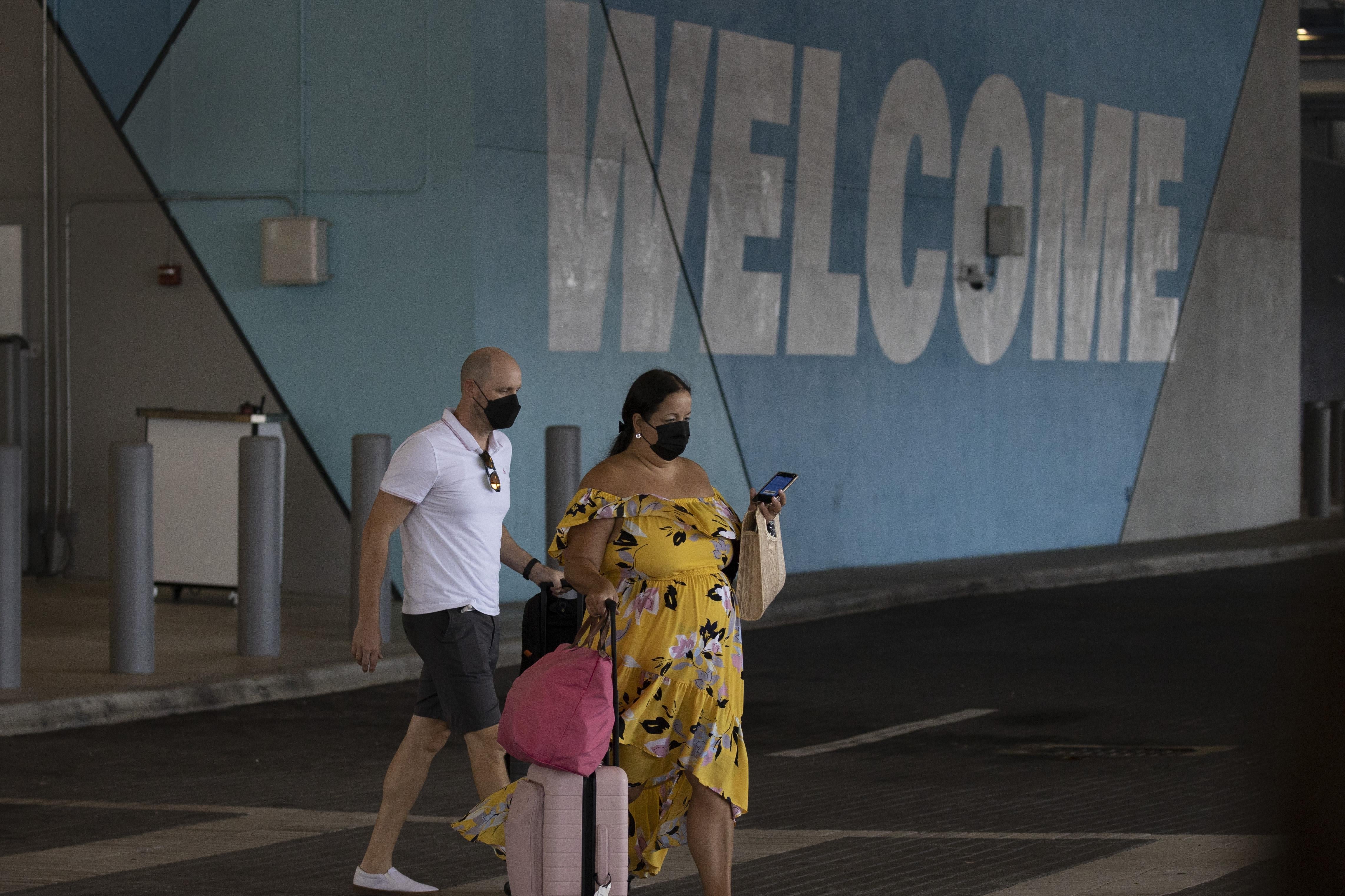 Passengers arrive as Royal Caribbean International prepares to sail the Freedom of the Seas from PortMiami during the first U.S. trial cruise testing COVID-19 protocols on June 20, 2021 in Miami, Florida.