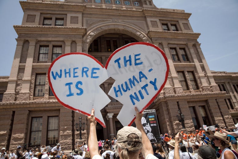 A demonstrator holds up a protest sign during a rally against the Trump administration's immigration policies outside of the Texas Capitol in Austin, Texas, on June 30, 2018.