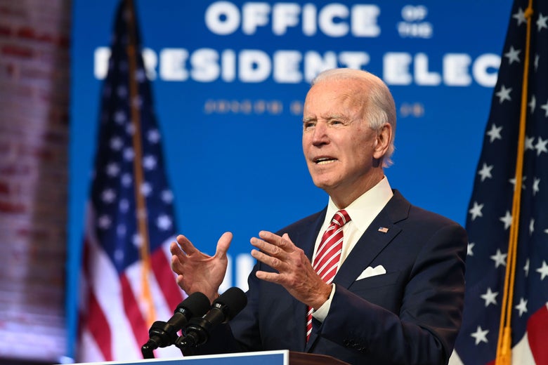 Joe Biden stands at a lectern in front of American flags and a sign that says "U.S. President Elect."