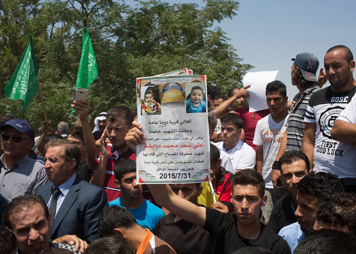 People gather in support of family members and relatives of 18-month-old Ali Dawabsheh as they hold his funeral on July 31, 2015, in the Palestinian village of Duma in the West Bank