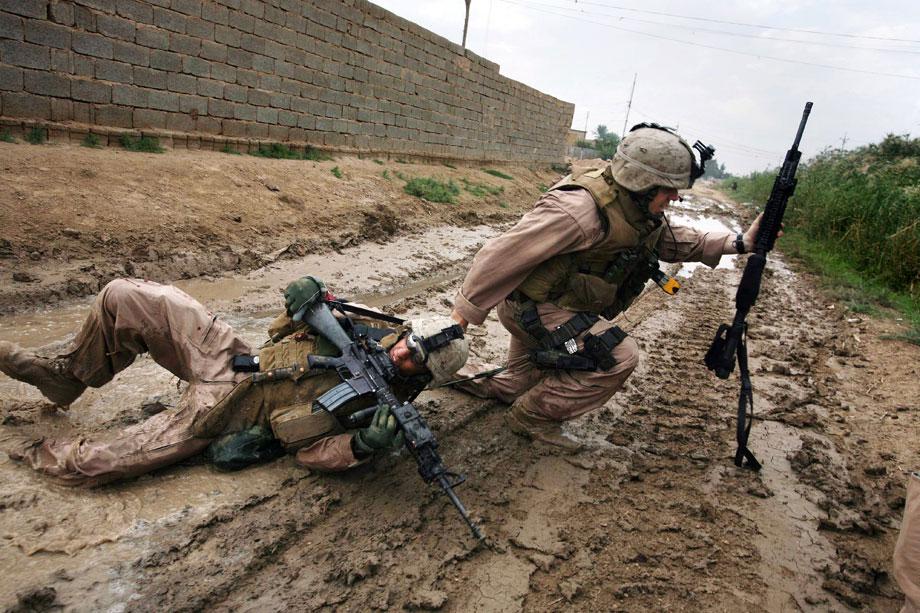 KARMAH, Iraq—Sgt. Jesse E. Leach drags Lance Cpl. Juan Valdez of Weapons Company, 2nd Battalion, 8th Marines, to safety moments after he was shot by a sniper during a patrol. Valdez was shot through the arm and right torso but survived, Oct. 31, 2006.