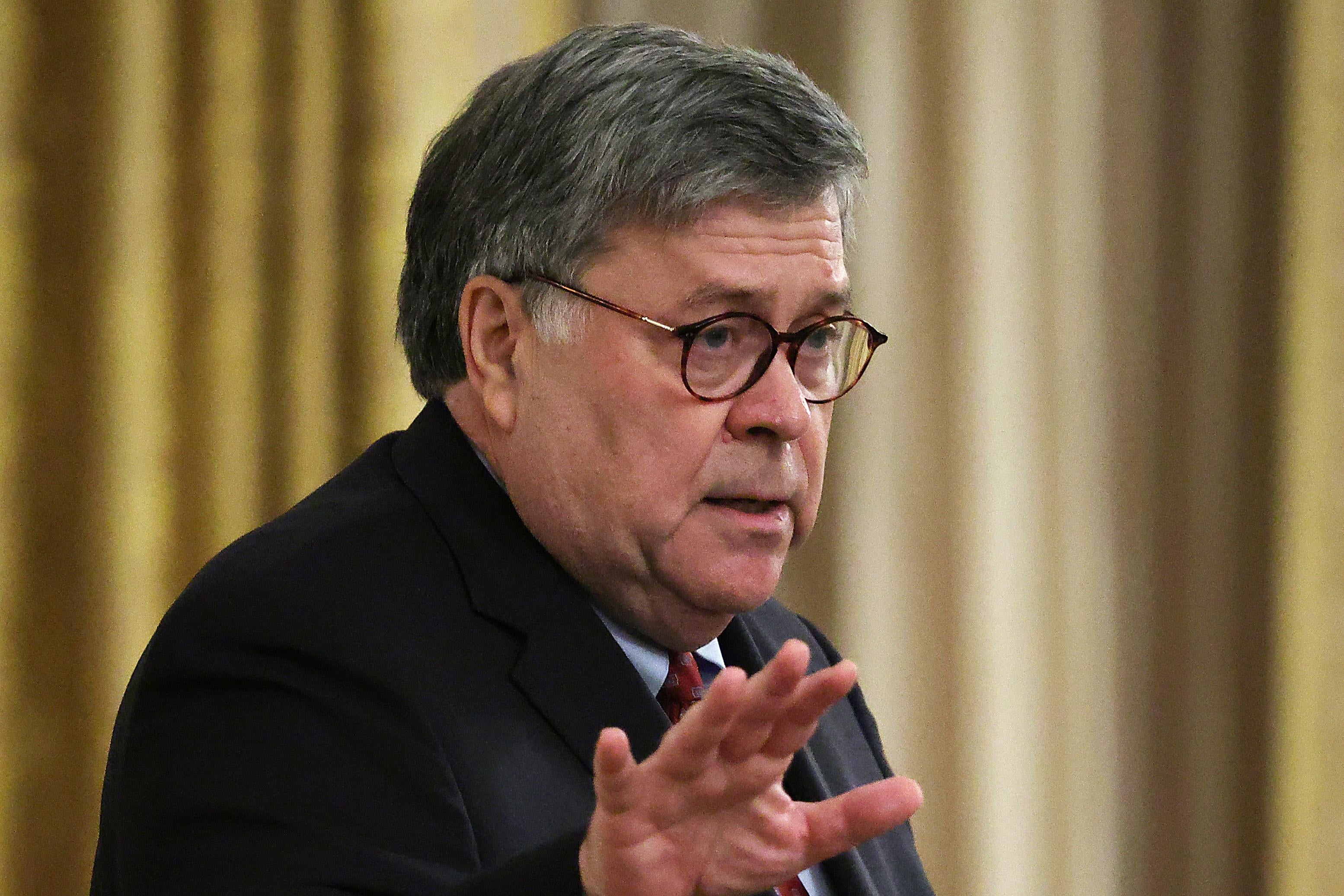 Barr, with outstretched arm, says something, probably misleading.