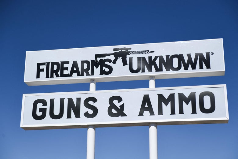 The silhouette AR-15 style rifle is displayed on signage for the Firearms Unknown Guns & Ammo gun store, in Yuma, Arizona on June 2, 2022.