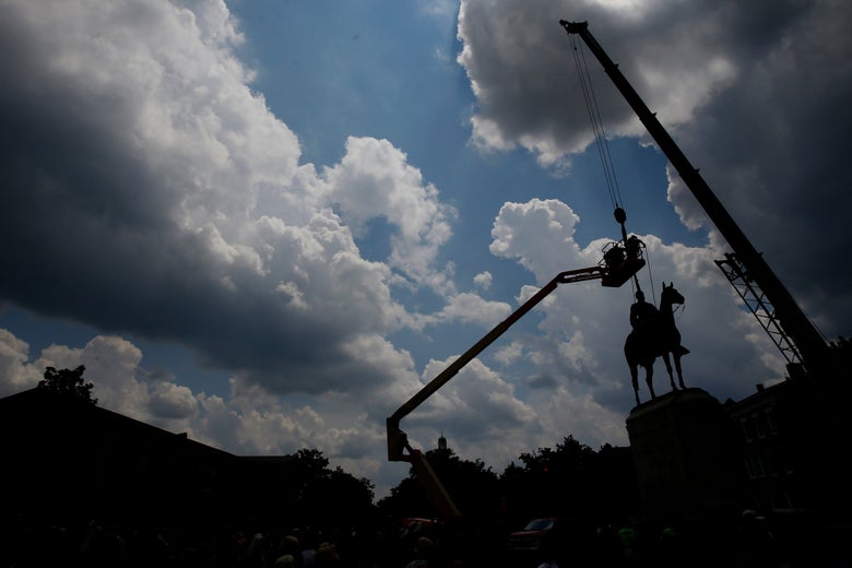 Statue being removed by a crane