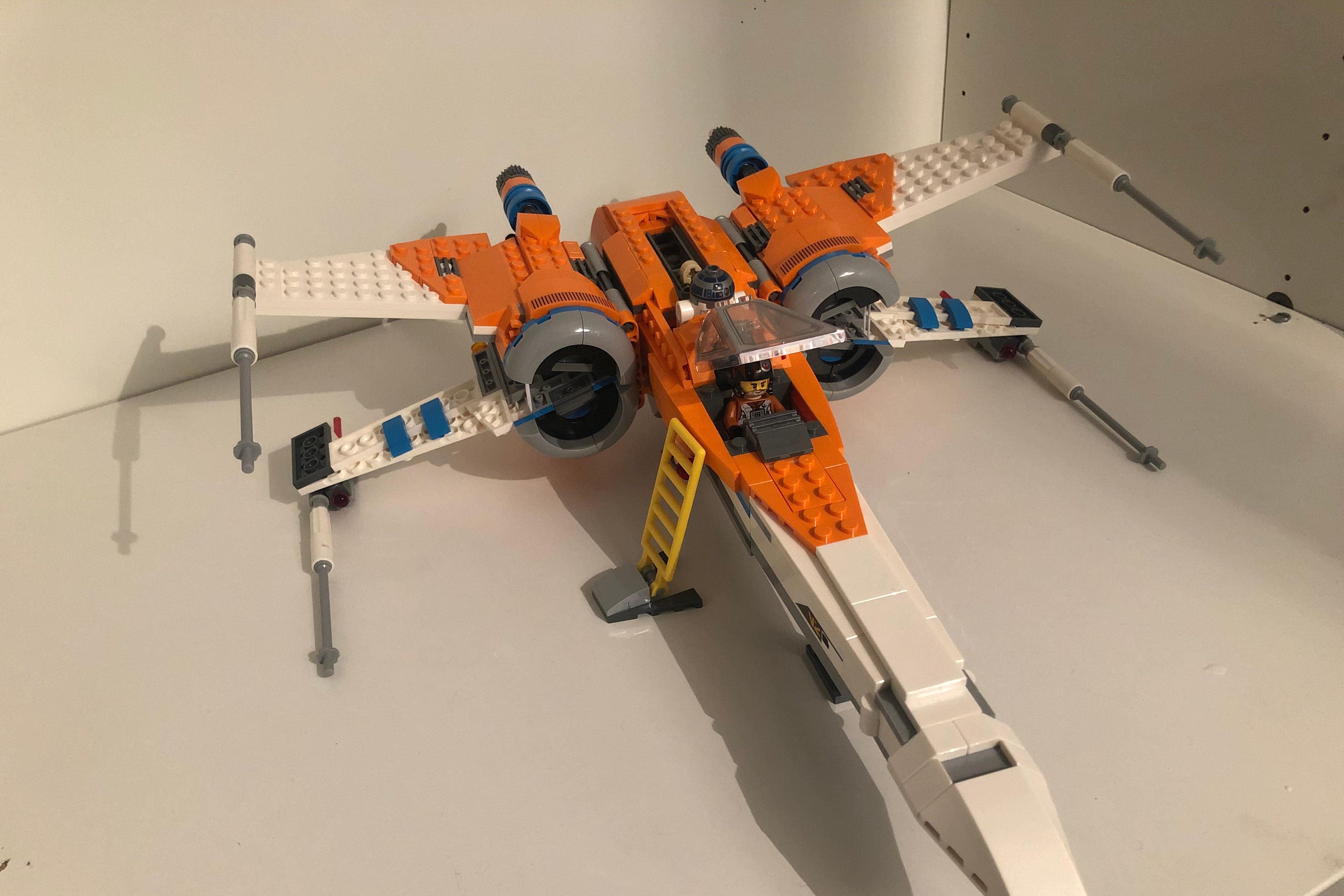 A Lego X-Wing sits on a table, complete, and immaculate