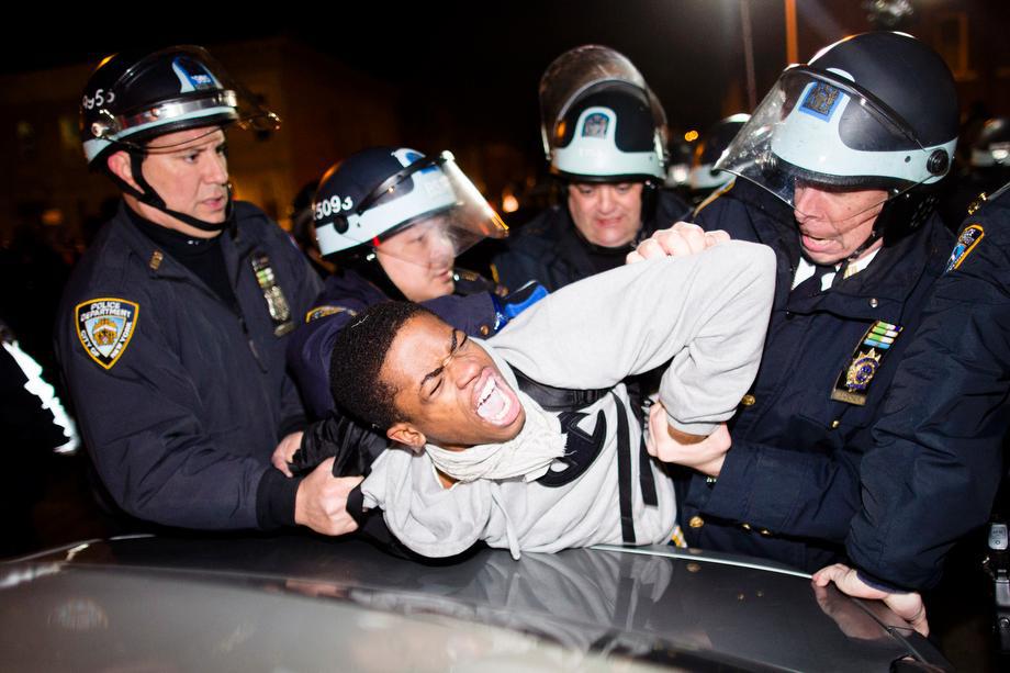 Police officers arrest a demonstrator during a march after a vigil held for Kimani "Kiki" Gray in the East Flatbush neighborhood of Brooklyn on March 13, 2013, in New York. 