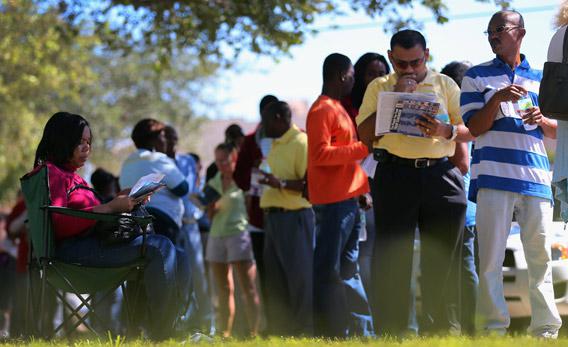 People wait in line to vote early on Wednesday in North Miami, Florida.