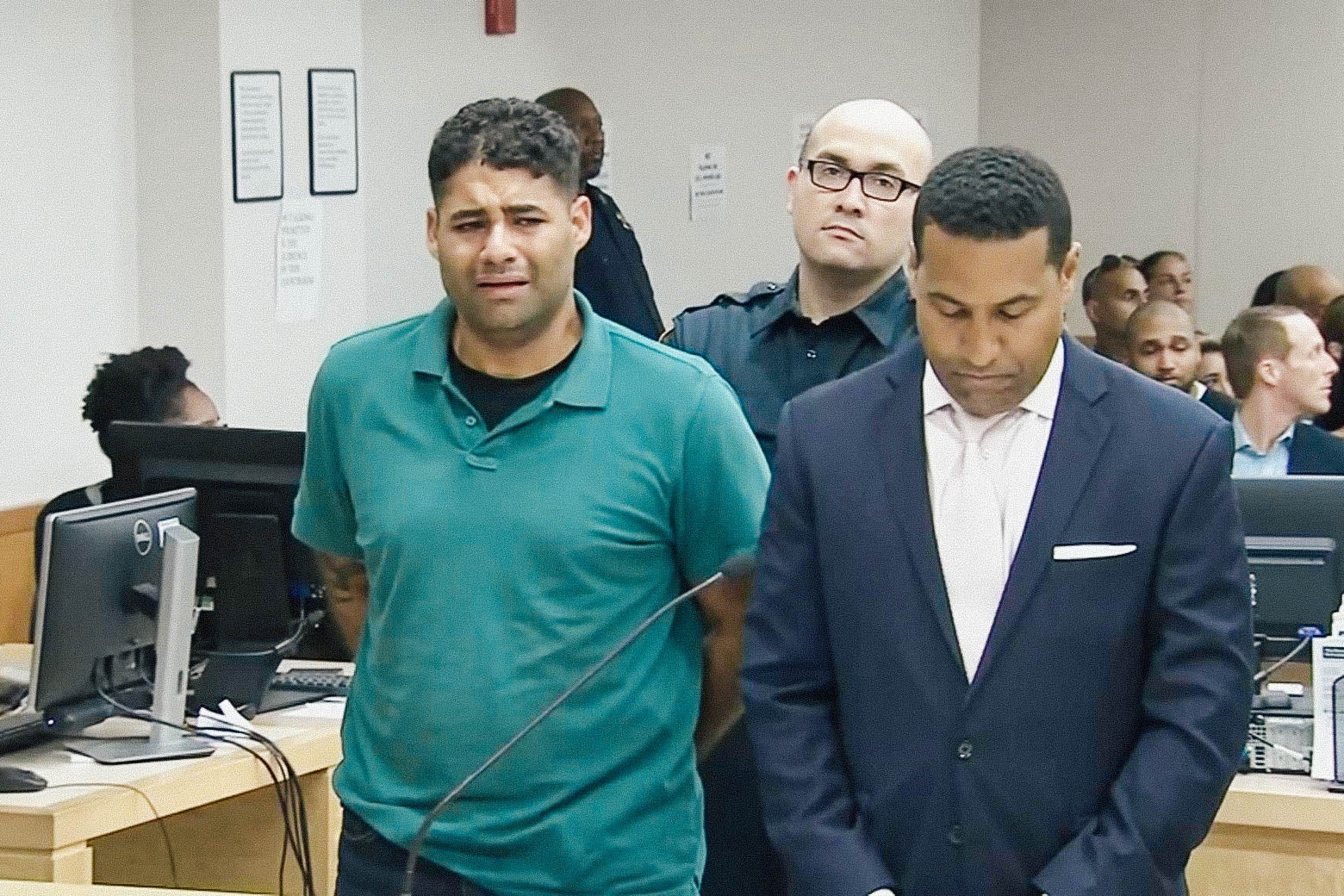 Juan Rodriguez looking anguished, standing with his arms behind his back in court.