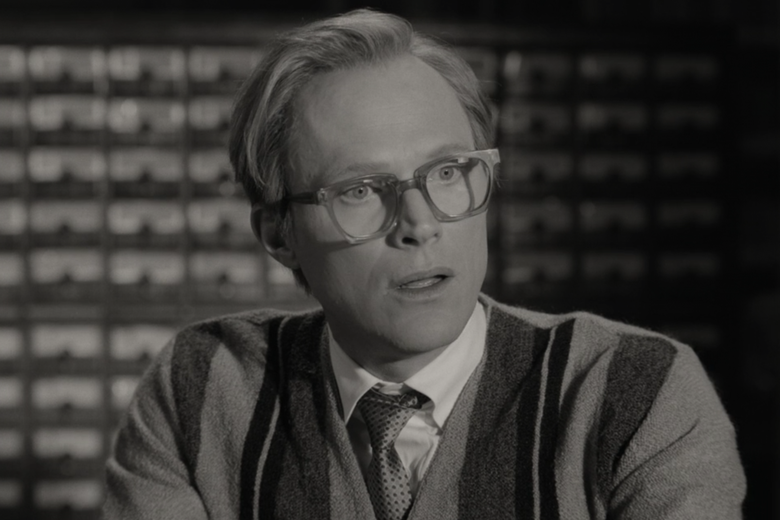 a man in glasses and a cardigan