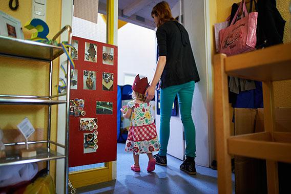 A Kindergarten teacher accompanies Mathilda, who celebrates her third birthday, in a Kindergarten on July 11, 2013 in Pfungstadt, Germany.