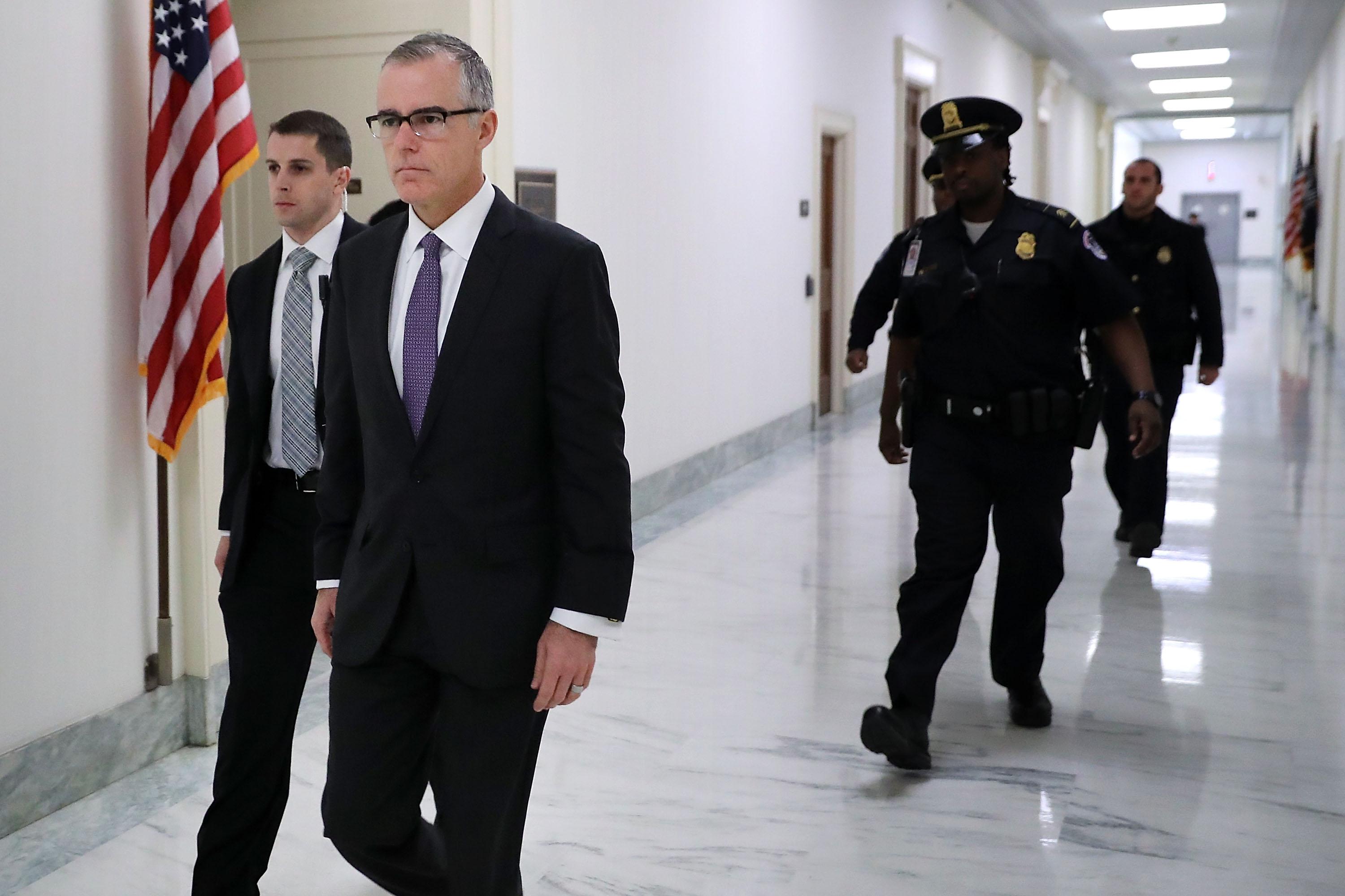 Andrew McCabe is escorted by U.S. Capitol Police before a meeting with members of the Oversight and Government Reform and Judiciary committees in the Rayburn House Office Building December 21, 2017 in Washington, DC.