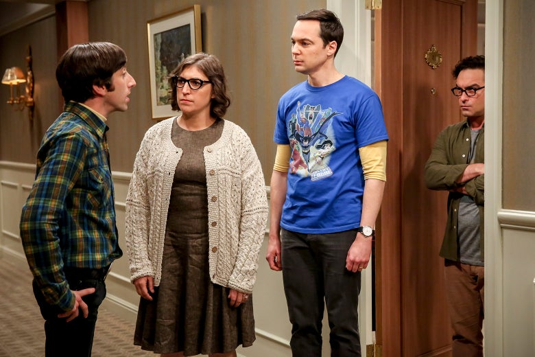 Simon Helberg, Mayim Bialik, Jim Parsons, and Johnny Galecki stand in a hallway in a still photo from the show.