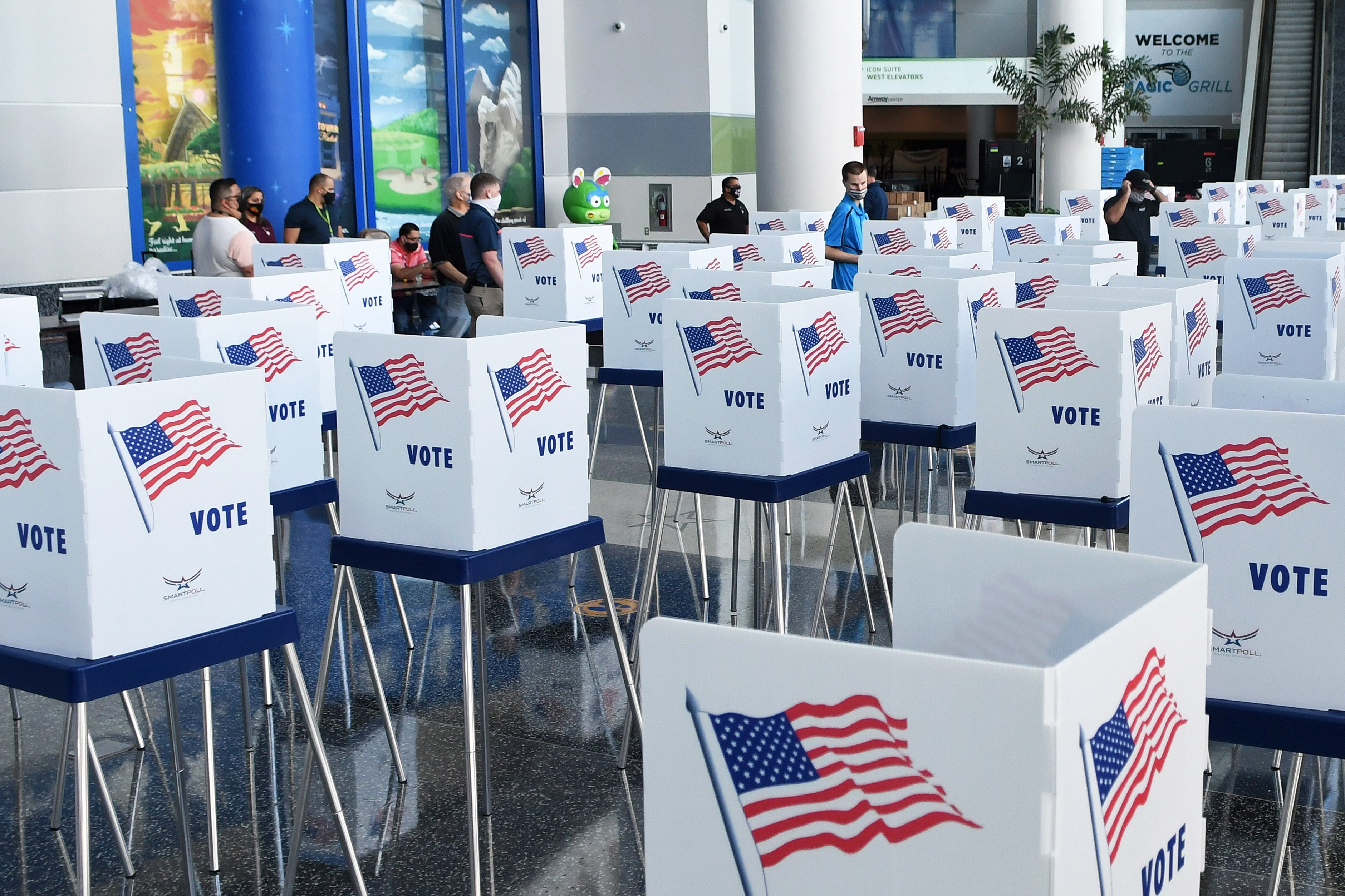 Election workers set up voting booths at the Amway Center, the home arena of the Orlando Magic, on Oct. 15, 2020.