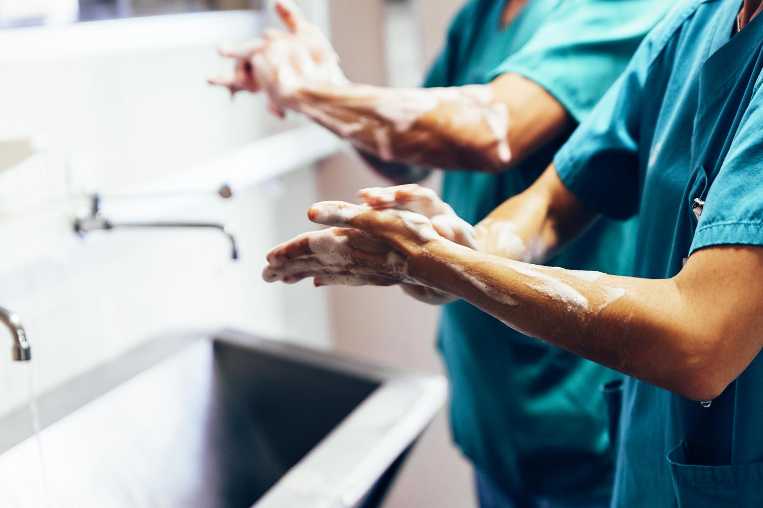 Medical professionals wash their hands.