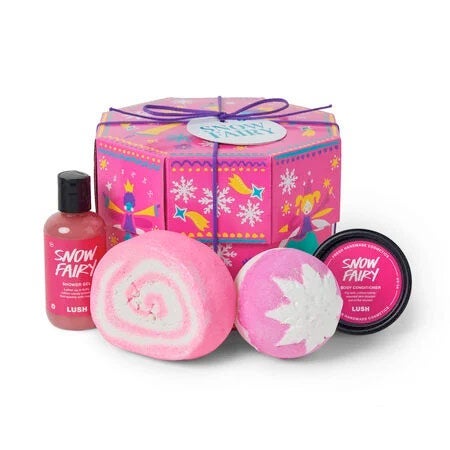 Festive pink octagonal gift box with two pink bath bombs, one small bottle of shower gel, and one small jar of body conditioner in front