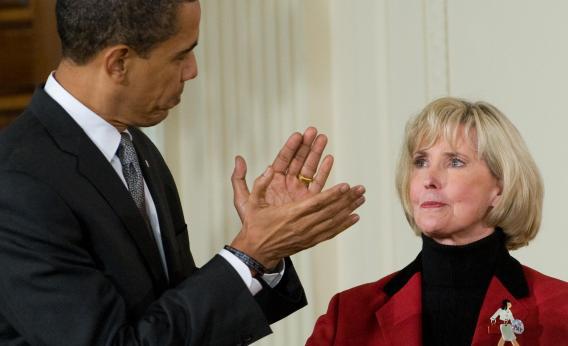 President Barack Obama applauds Lilly Ledbetter before signing the Lilly Ledbetter Fair Pay Act on Jan. 29, 2009