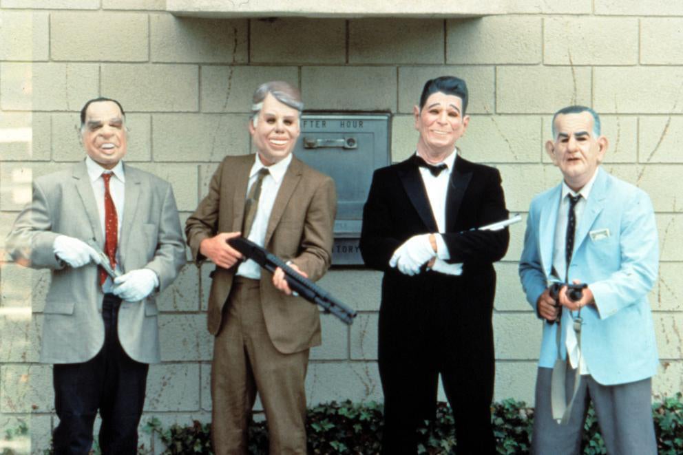 Four bank robbers from Point Break, wearing masks with the faces of presidents on them.