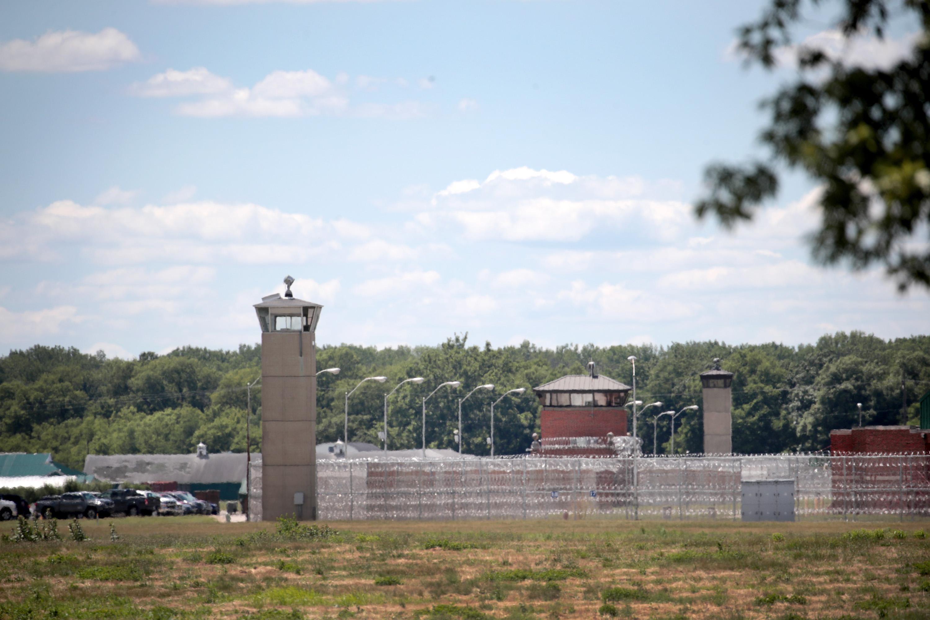 A guard tower sits along a security fence at the Federal Correctional Complex