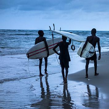 Samuel, Ronald, and Samson walk along the beach at dusk after a successful afternoon in the water, May 5, 2014.