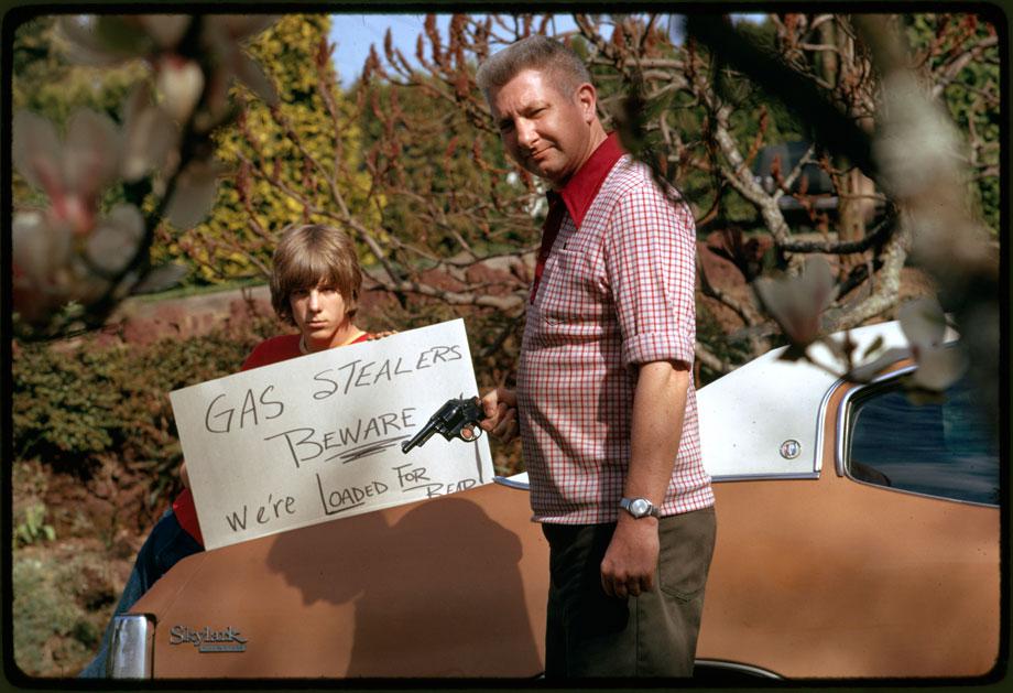 Country’s fuel shortage led to problems for motorists in finding gas as well as paying much more of it, and resulted in theft from cars left unprotected. This father and son, made a sign warning thieves of the possible consequences”, April 1974Photographer: FalconerSeries: Photographs and other Graphic Materials from the Environmental Protection Agency, (12/09/1970-)Record Group 412: Records of the Environmental Protection Agency, 1944-2006ARC Series Identifier: 553111Still Pictures Identifier: 412-DA-10652Rediscovery Identifier: 25270
