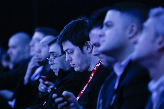 Audience members are tinted by stage lights while using their smartphones during Research in Motion's (RIM) launch of their Blackberry 10 devices in New York January, 2013.