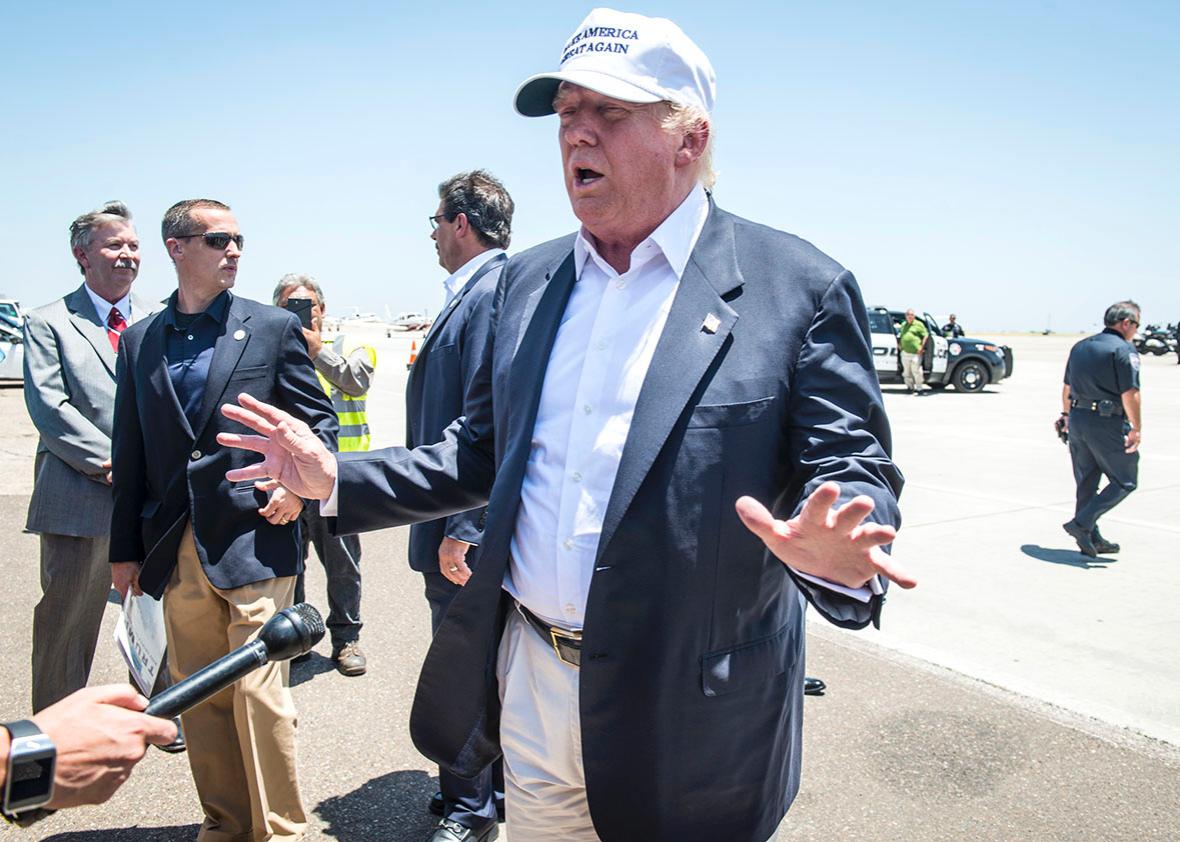 Republican Presidential candidate and business mogul Donald Trum,Republican Presidential candidate and business mogul Donald Trump talks to the media after exiting his plane during his trip to the border.
