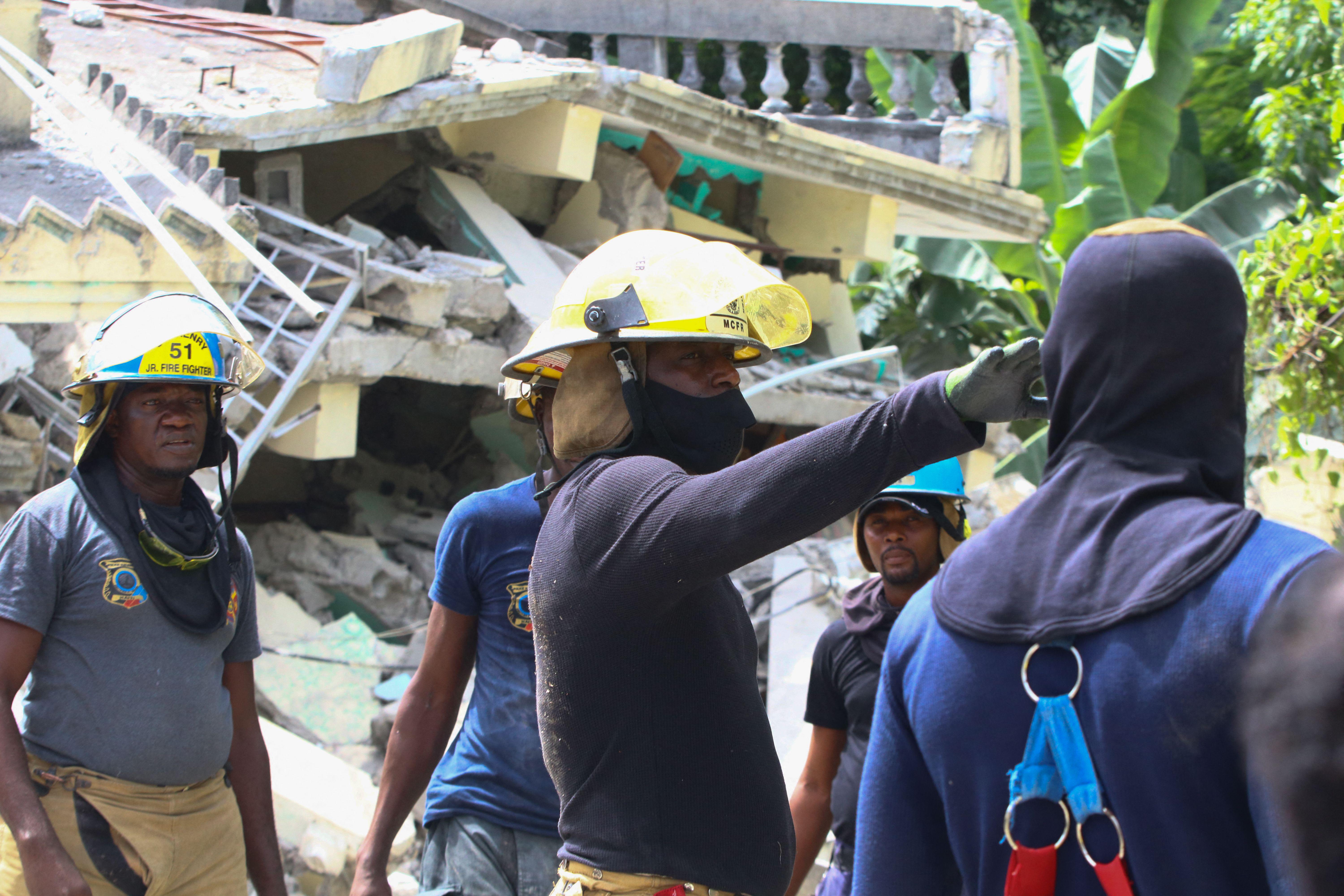 Rescuers race to find Haiti quake survivors as tropical storm approaches.