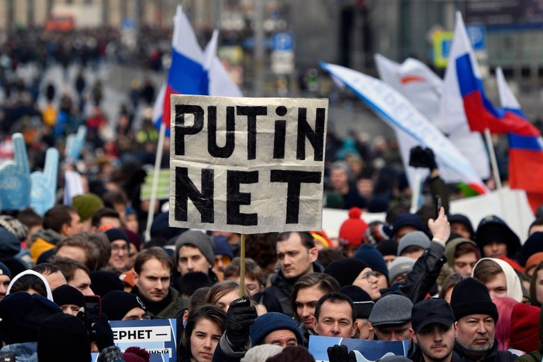 A protester holds up a sign that reads, "Putin net."