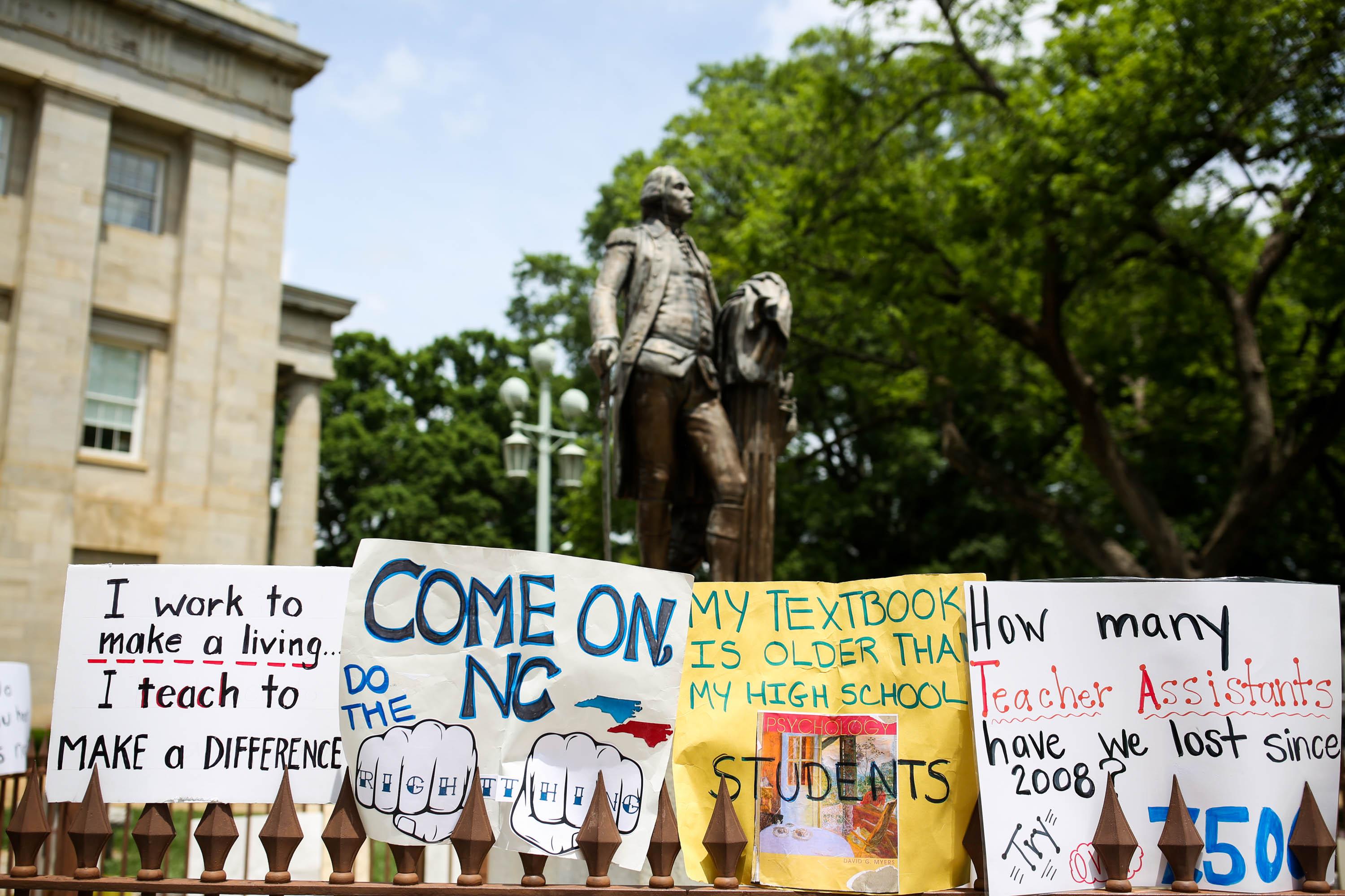 Protest signs lean against the state capitol building in Raleigh, North Carolina.