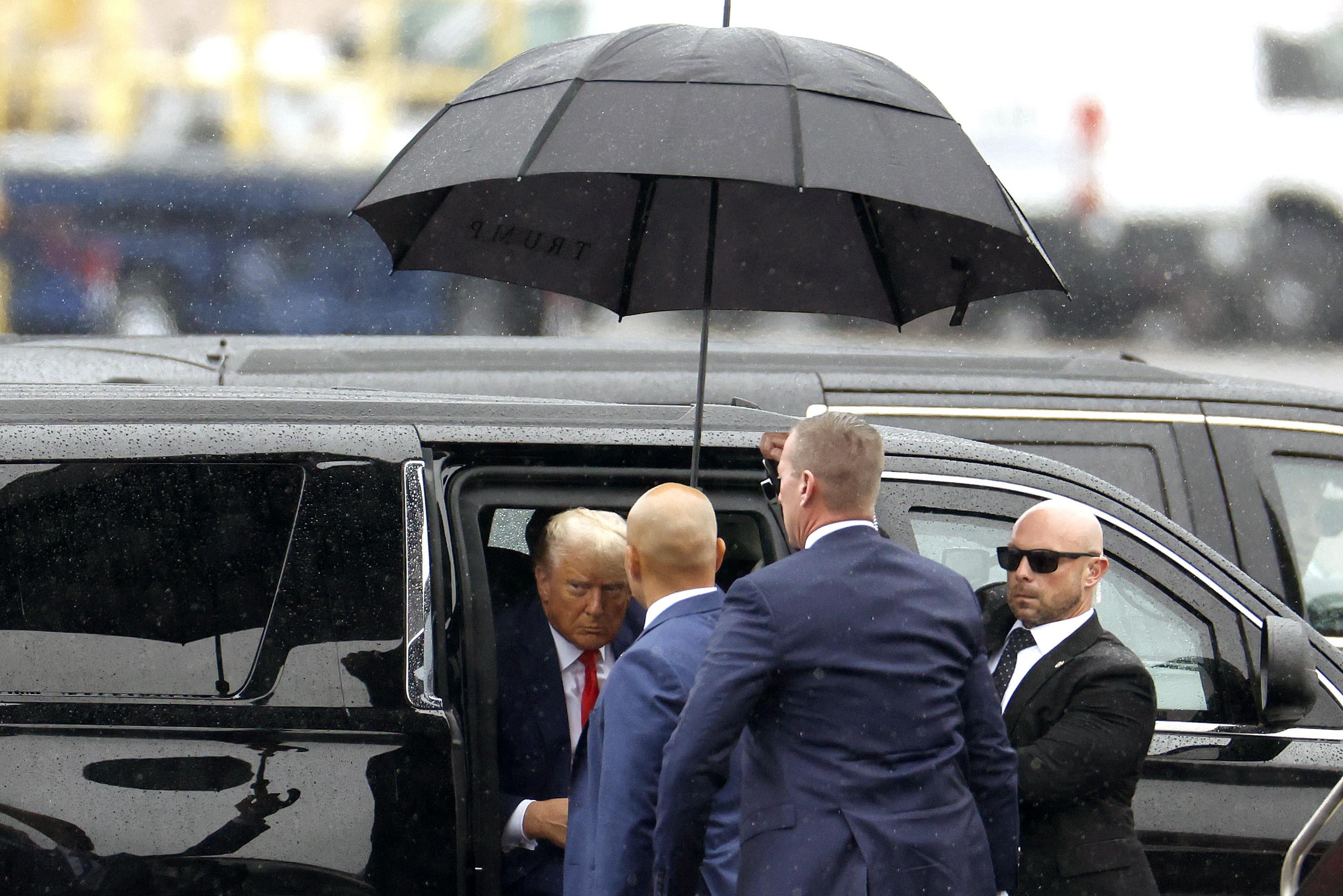 Former U.S. President Donald Trump getting out of a car.