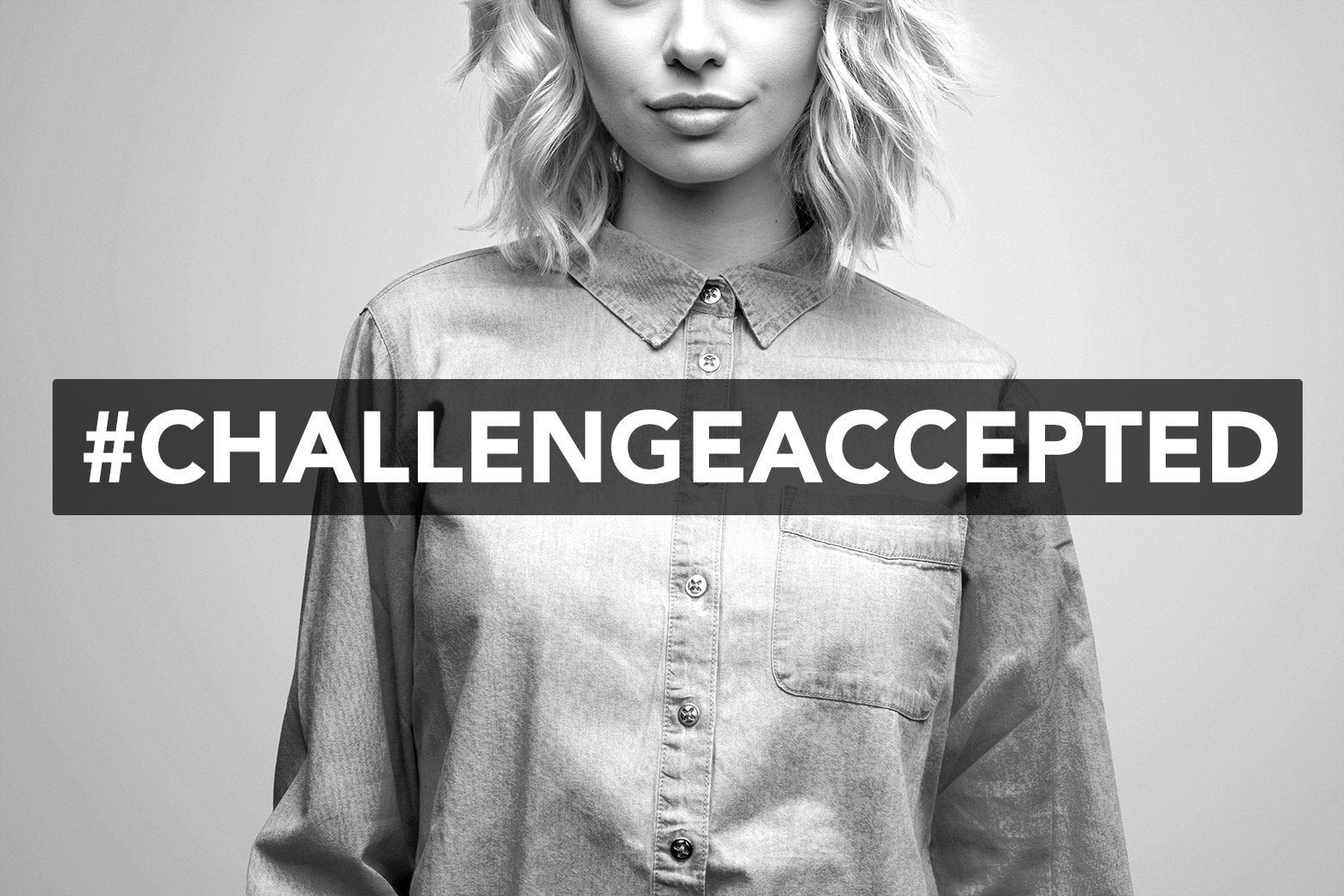 A woman posing with a #ChallengeAccepted hashtag.