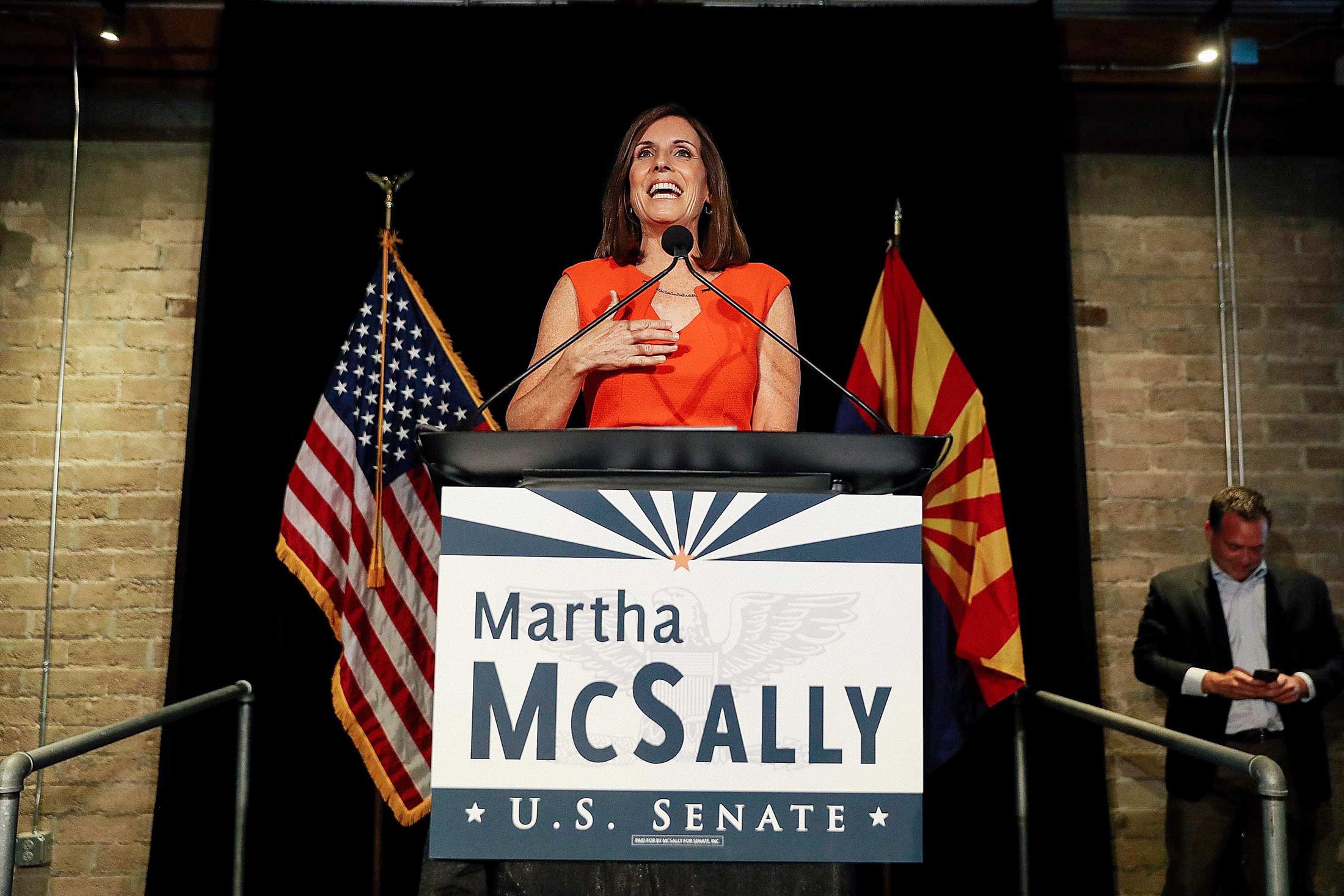 Martha McSally speaks from behind a podium that says "Martha McSally U.S. Senate."