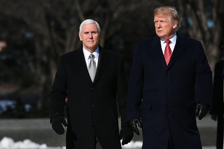President Donald Trump and Vice President Mike Pence in winter coats and gloves.