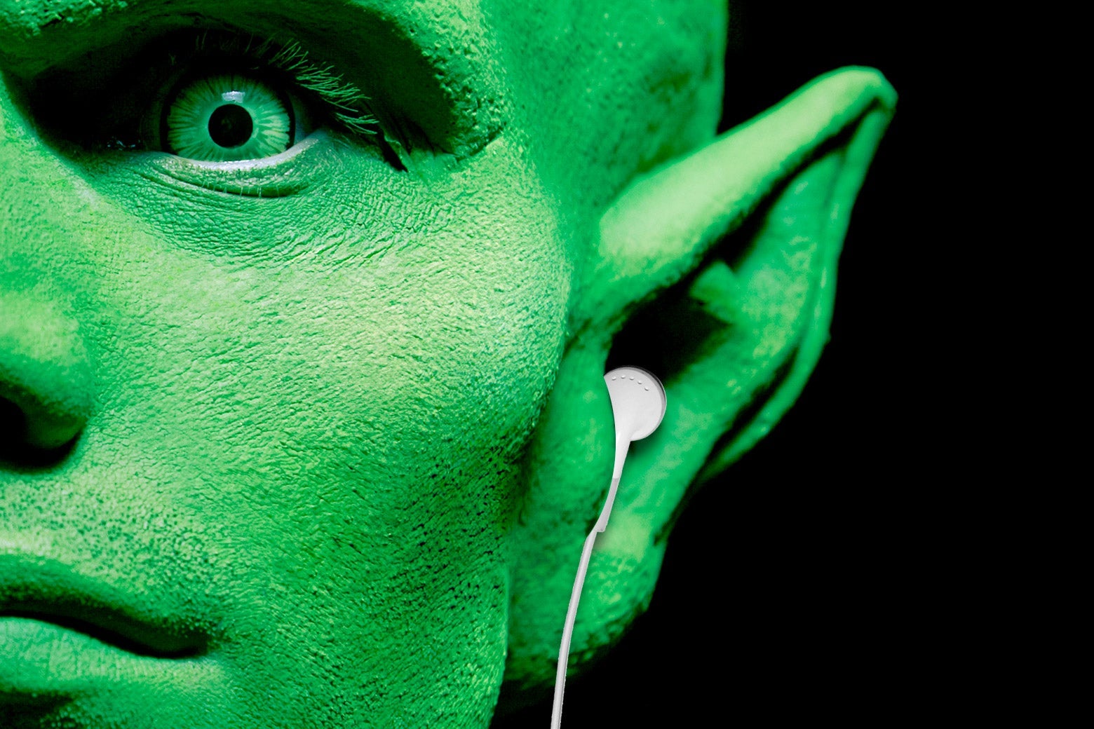 Photo illustration of an alien wearing headphones.