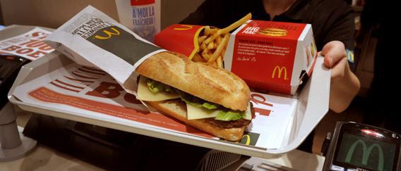 A worker shows the McBaguette, the French "baguette" sold by US fast food giant McDonald's in their French outlets.