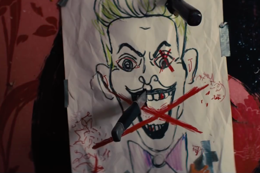 A crude drawing of the green-haired Joker with the letter X drawn over him and knives sticking out of the paper.