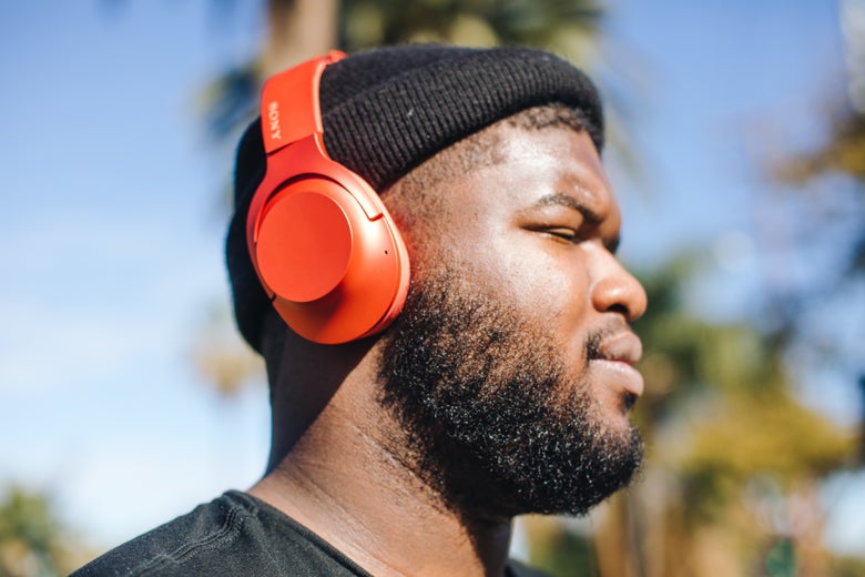 man wearing red Sony headphones