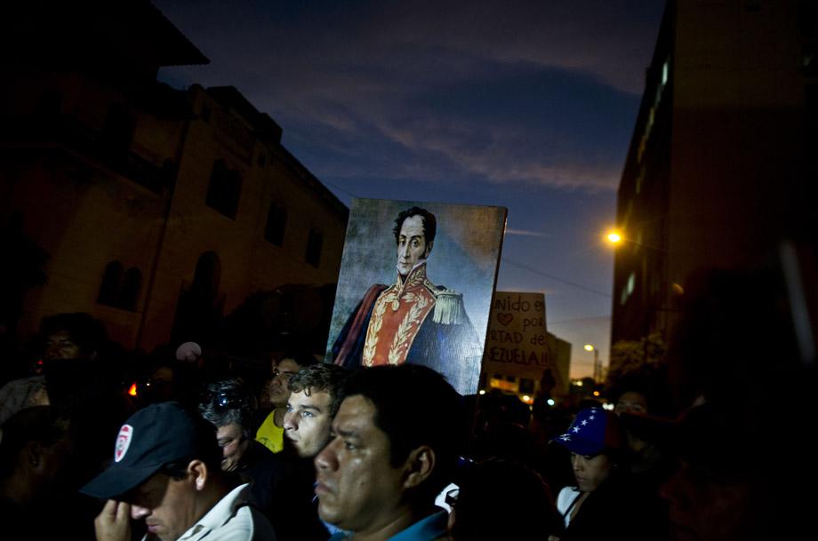 Demonstrators protest against Venezuela's President Nicolas Maduro outside Venezuela's embassy in Lima on February 18, 2014. 