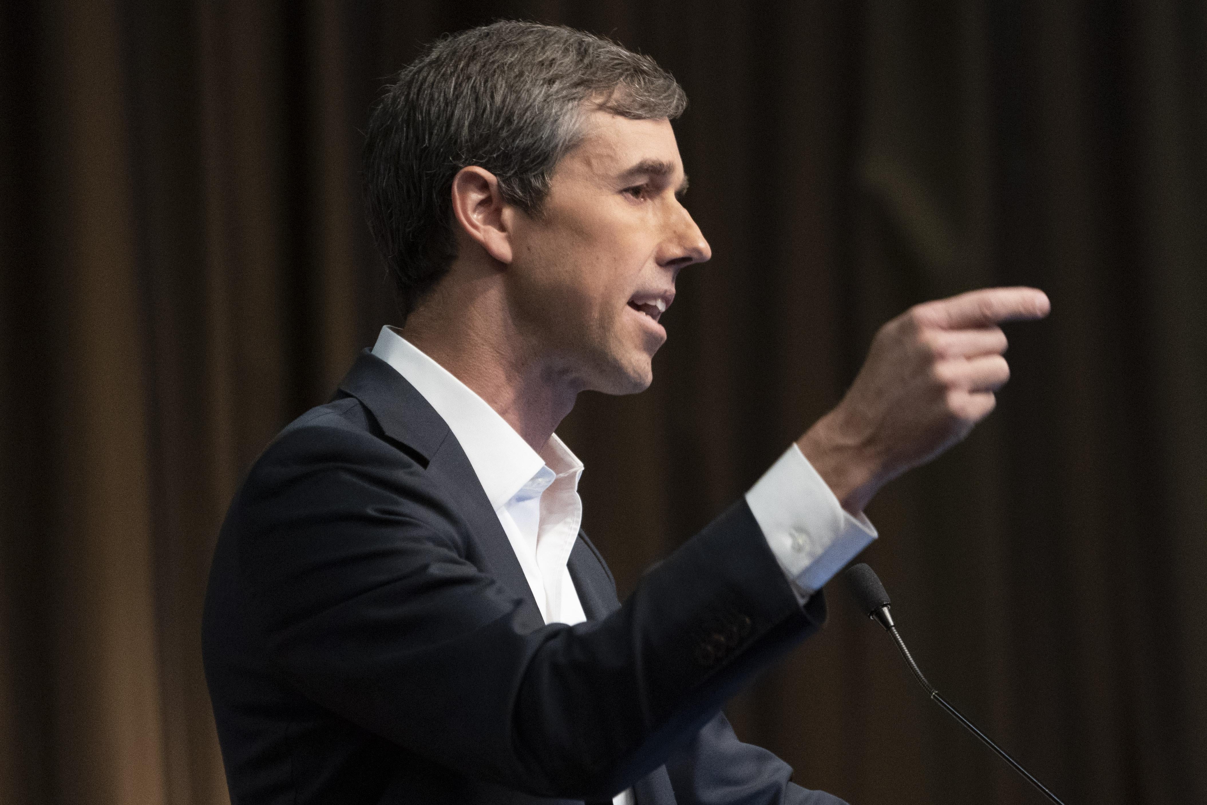 Beto O'Rourke gesticulates while speaking at an event.
